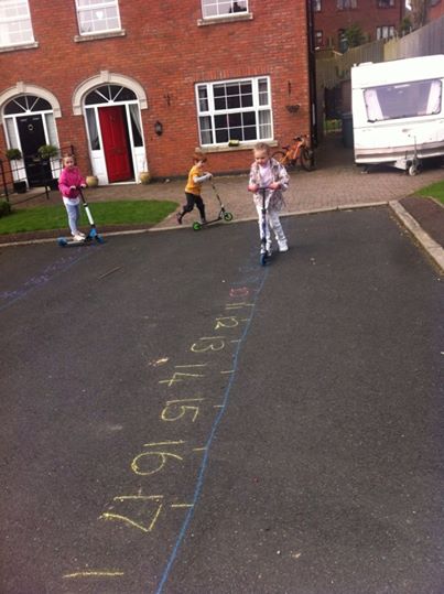 Children learning maths by cycling over a large number line