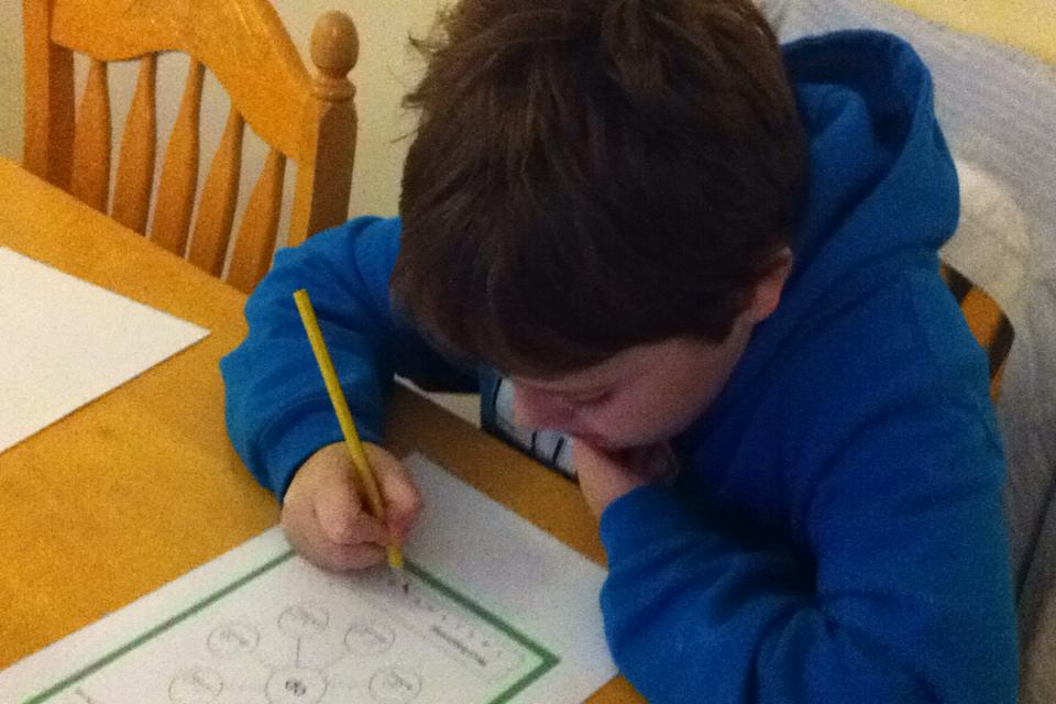 Child writing on a worksheet